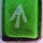 close-up of green bottle with acid etched arrow